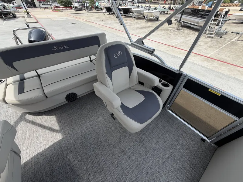 Slide: The Image of The image shows the interior of a 2024 Barletta A20UC pontoon boat with gray seating. - 24