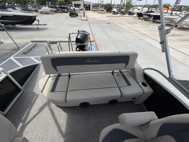 Slide: The Image of The image shows the rear seating area of a 2024 Barletta A20UC boat on a lot. - 26