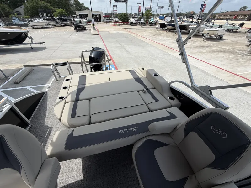 Slide: The Image of The image shows the deck of a 2024 Barletta A20UC boat parked in a lot. - 28