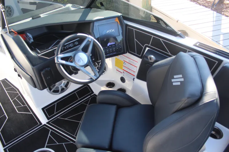 Slide: The Image of 2024 ATX Surf Boats 22 Type-S cockpit with sleek steering wheel and modern dashboard. - 11