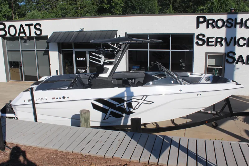 Slide: The Image of 2024 ATX Surf Boats 22 Type-S displayed at a dealership, showcasing sleek design. - 2