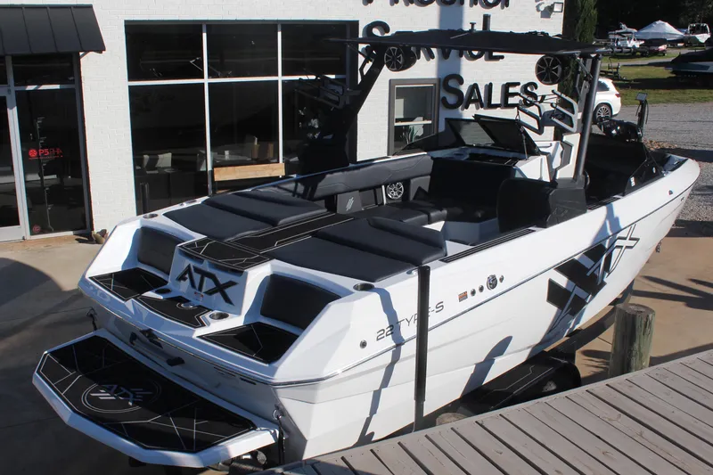 Slide: The Image of 2024 ATX Surf Boats 22 Type-S, sleek design, docked at dealership, ready for adventure. - 3