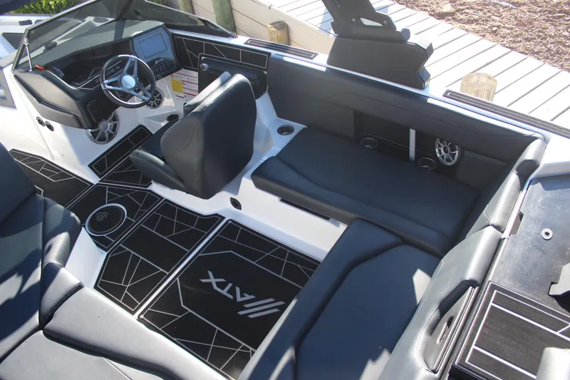 Slide: The Image of 2024 ATX Surf Boats 22 Type-S interior with sleek black seating and modern dashboard design. - 9