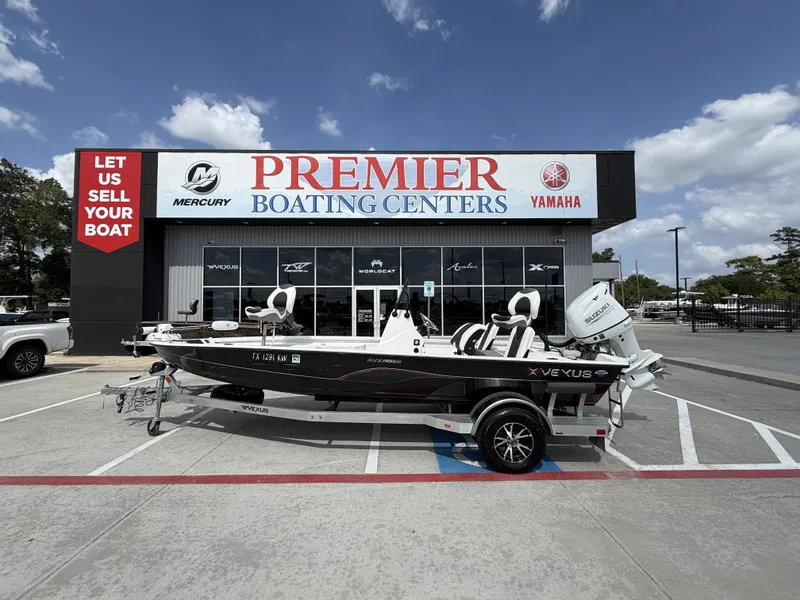 The Image of A 2022 Vexus AVX1980CC boat on a trailer in front of a boating center. - 1