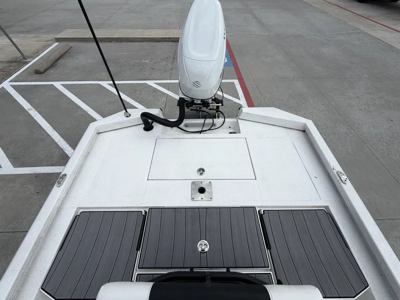 Slide: The Image of The image shows the deck of a 2022 Vexus AVX1980CC boat with an outboard motor. - 14
