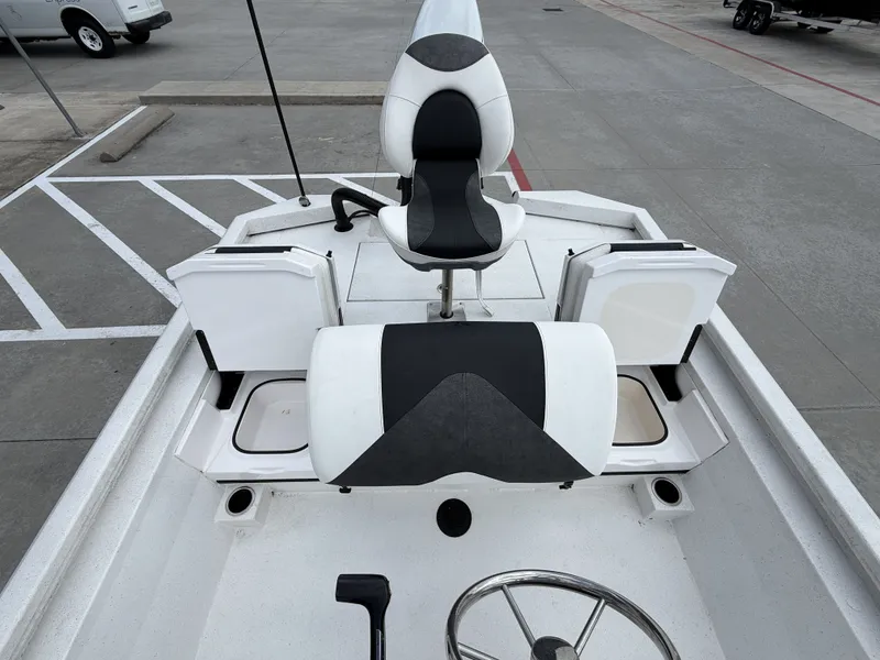 Slide: The Image of The image shows the cockpit of a Vexus AVX1980CC boat with a central seat and controls. - 15