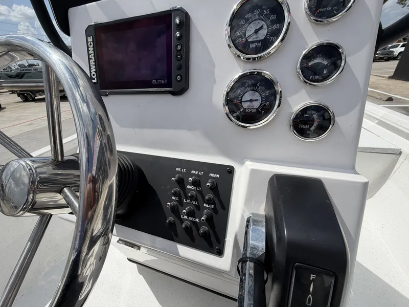 Slide: The Image of Close-up of a Vexus AVX1980CC boat's helm with instruments and controls. - 23