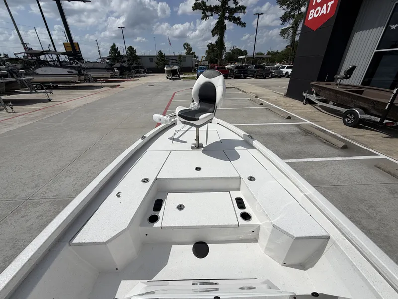 Slide: The Image of A 2022 Vexus AVX1980CC boat is parked. It features a white deck and a seat. - 25