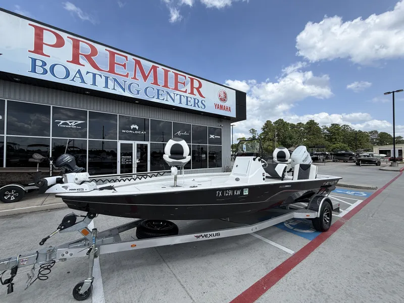 Slide: The Image of A 2022 Vexus AVX1980CC boat on a trailer outside a boating center. - 3