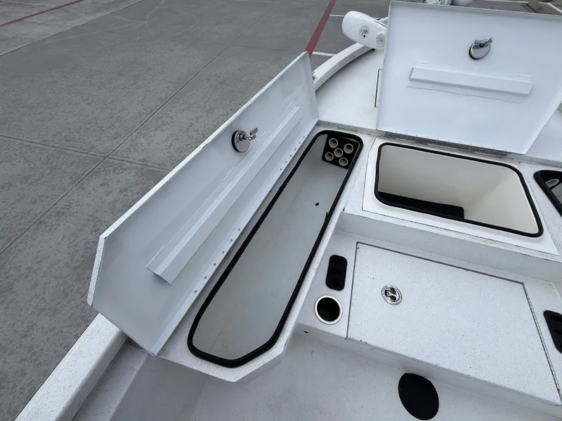Slide: The Image of The image shows the deck of a 2022 Vexus AVX1980CC boat with open storage compartments. - 30