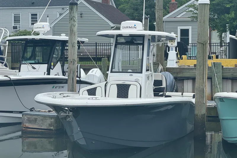 The Image of 2022 Tidewater 232 SS boat docked, featuring Garmin equipment, in a marina setting. - 0