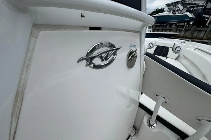 Slide: The Image of 2022 Tidewater 232 SS boat interior with logo and seating details. - 10