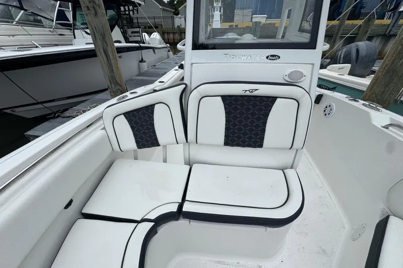 Slide: The Image of 2022 Tidewater 232 SS boat interior with cushioned seating and sleek design. - 15