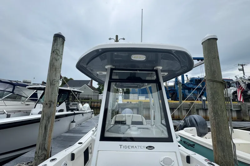 Slide: The Image of 2022 Tidewater 232 SS boat docked at marina, showcasing sleek design and modern features. - 16
