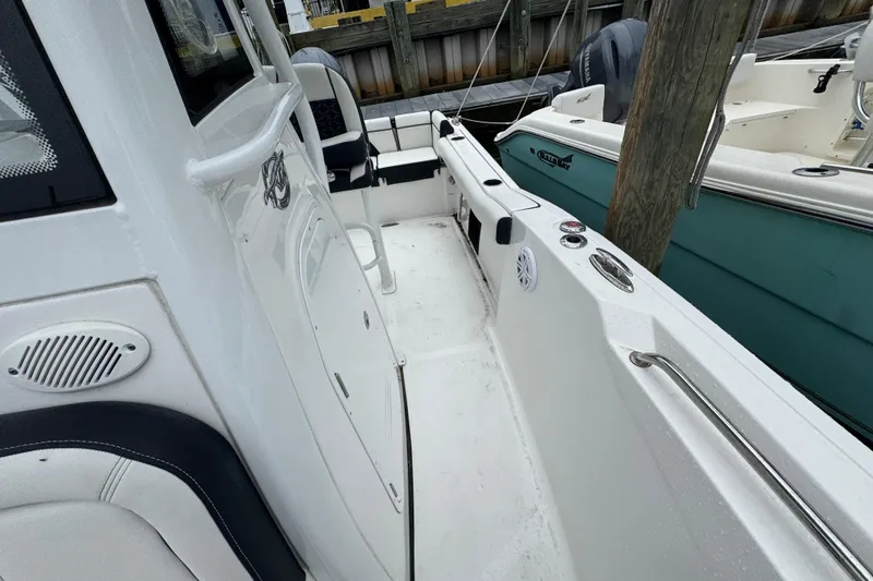 Slide: The Image of 2022 Tidewater 232 SS boat interior, featuring sleek white design and comfortable seating. - 17