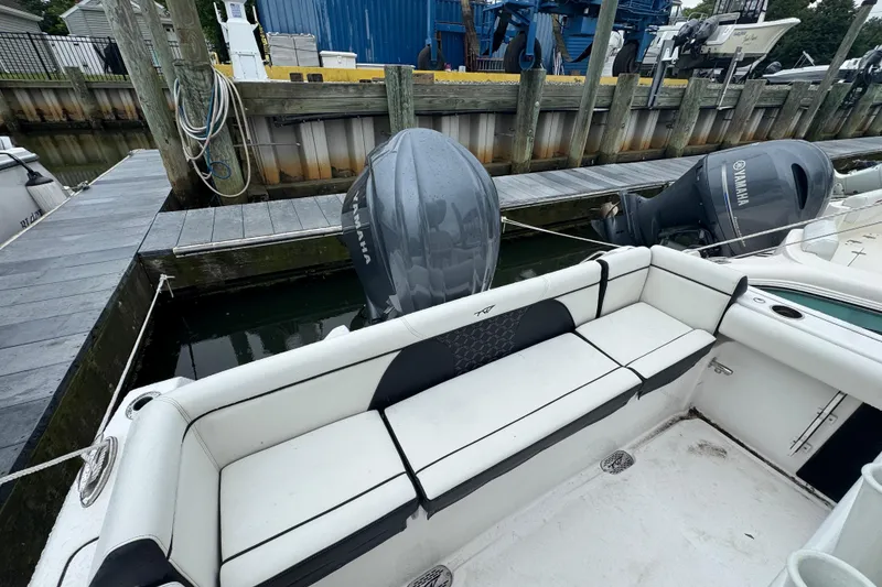 Slide: The Image of 2022 Tidewater 232 SS boat docked, featuring Yamaha outboard engines and spacious seating. - 2