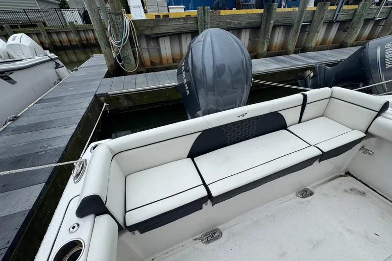 Slide: The Image of 2022 Tidewater 232 SS boat with Yamaha outboard, docked with white seating. - 21