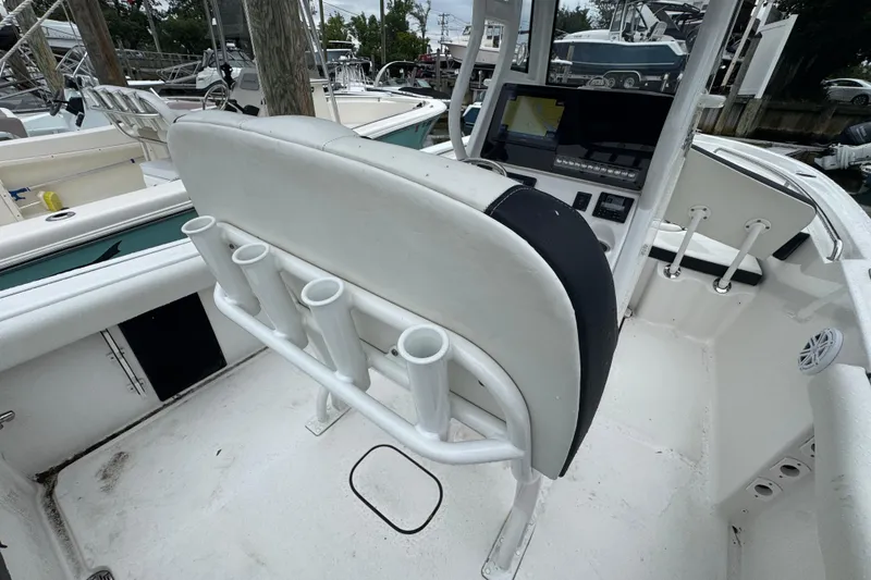Slide: The Image of 2022 Tidewater 232 SS boat interior with rod holders and navigation console. - 3