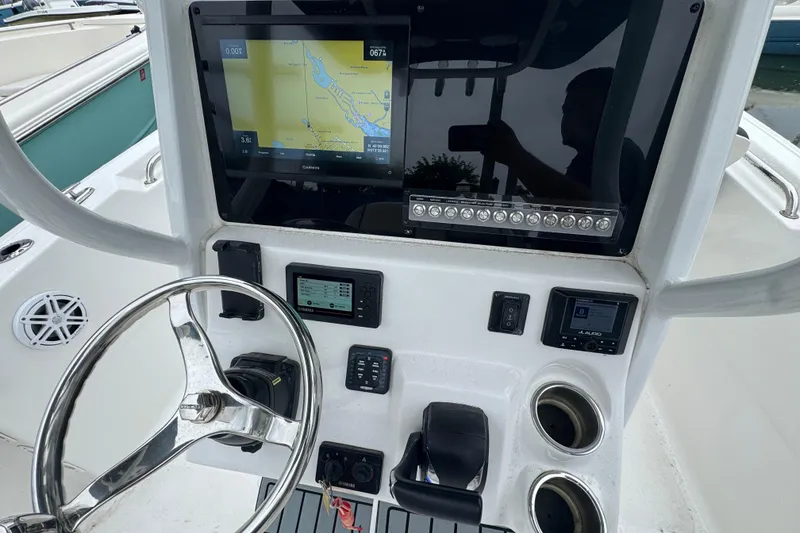 Slide: The Image of 2022 Tidewater 232 SS boat dashboard with navigation screen and controls. - 5