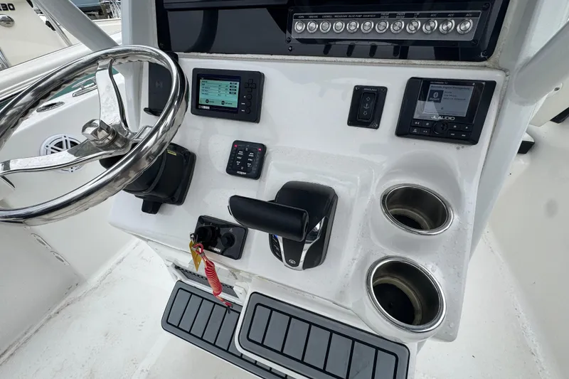 Slide: The Image of Control panel of 2022 Tidewater 232 SS boat with steering wheel and electronics. - 9