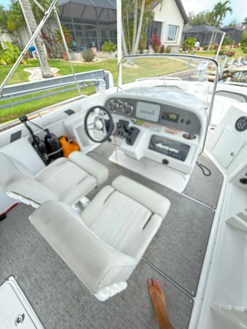Slide: The Image of The image shows the cockpit of a 2022 Hurricane 231 SS boat with two white seats. - 10