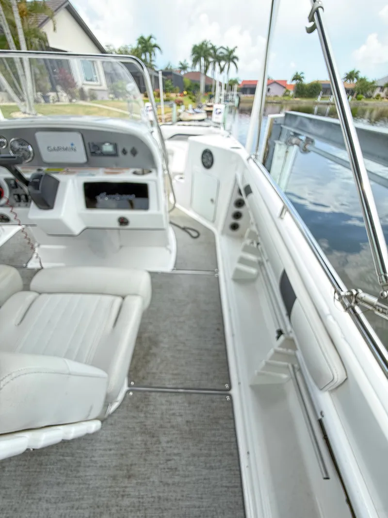 Slide: The Image of The image shows the cockpit of a 2022 Hurricane 231 SS boat with white seats and a helm console. - 11
