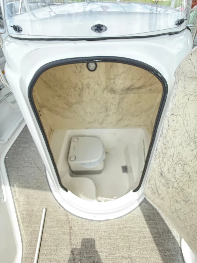Slide: The Image of The image shows a boat toilet in a white cabin area. - 19