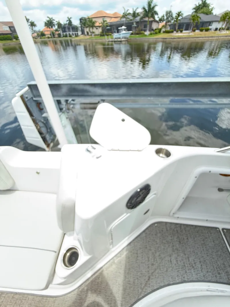 Slide: The Image of The image shows the deck of a 2022 Hurricane 231 SS boat, overlooking the water. - 20