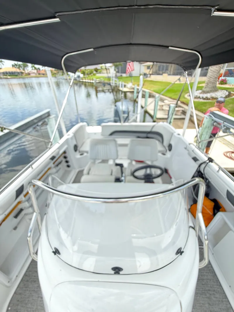 Slide: The Image of The image shows a 2022 Hurricane 231 SS boat with a black sunshade. - 21