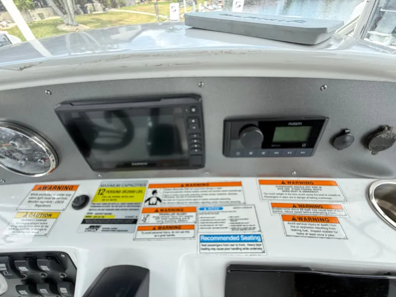 Slide: The Image of The dashboard of a boat with navigation system and warning labels. - 22