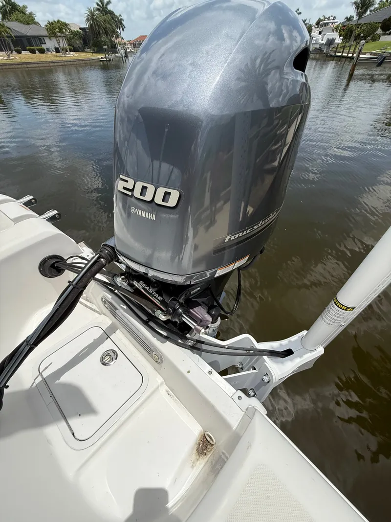 Slide: The Image of A Yamaha outboard motor on a boat, situated on calm water. - 25