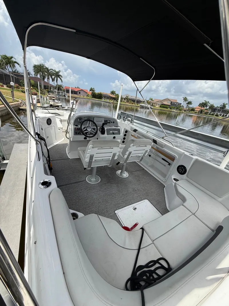 Slide: The Image of The image shows the cockpit of a 2022 Hurricane 231 SS boat with white seating and gray carpet. - 6