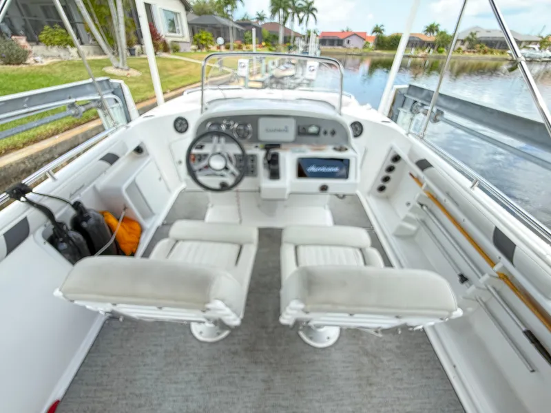 Slide: The Image of The cockpit of a 2022 Hurricane 231 SS with two white seats and a helm station. - 8