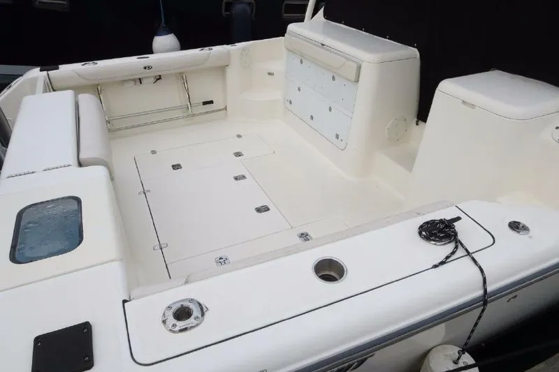 Slide: The Image of 2010 Pursuit OS 345 Offshore boat deck with storage compartments and seating. - 7