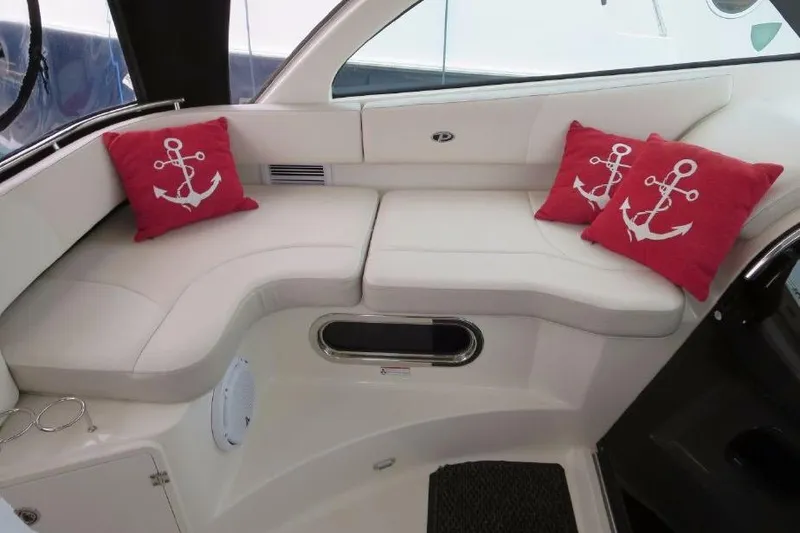 Slide: The Image of Luxurious seating area on 2010 Pursuit OS 345 Offshore boat with anchor-themed cushions. - 12