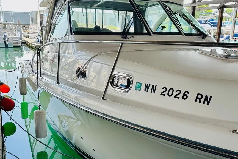 Slide: The Image of 2010 Pursuit OS 345 Offshore boat docked, displaying registration number WN 2026 RN. - 5