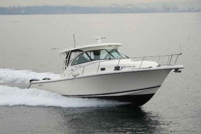Slide: The Image of 2010 Pursuit OS 345 Offshore boat cruising on calm waters. - 2