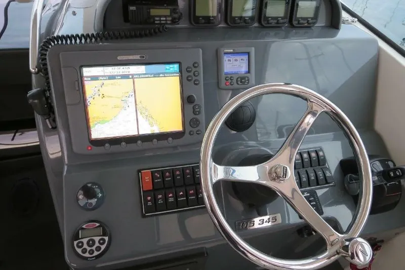 Slide: The Image of Control panel of a 2010 Pursuit OS 345 Offshore boat with navigation equipment. - 11