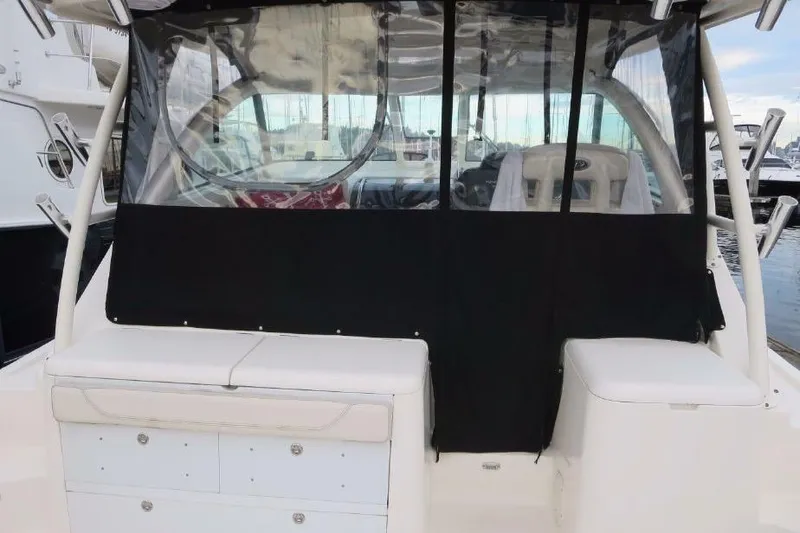 Slide: The Image of 2010 Pursuit OS 345 Offshore boat with covered cockpit and seating area. - 10