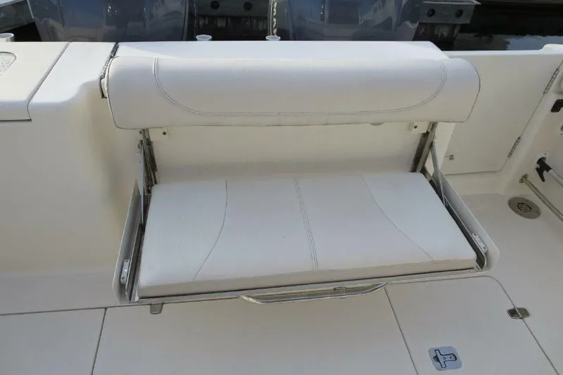 Slide: The Image of Foldable white seat on a 2010 Pursuit OS 345 Offshore boat. - 9