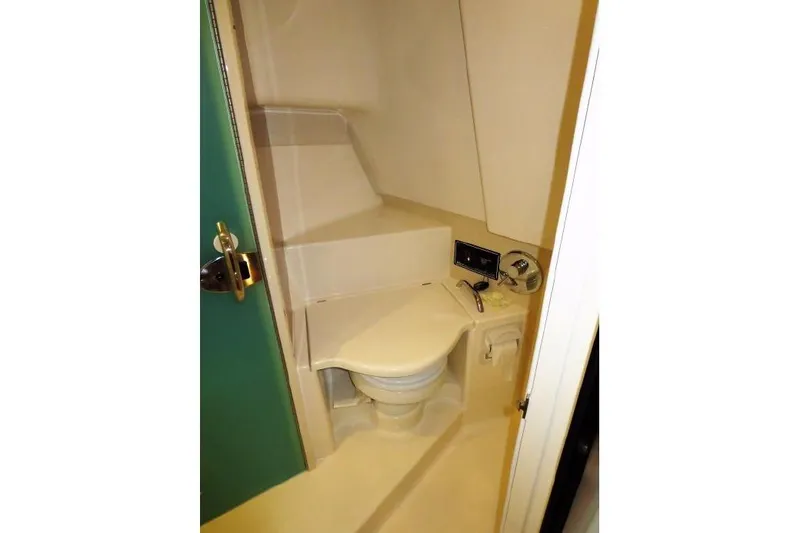 Slide: The Image of 2010 Pursuit OS 345 Offshore boat bathroom with compact toilet and sink. - 19