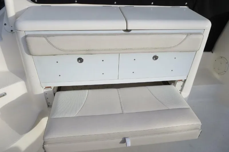 Slide: The Image of 2010 Pursuit OS 345 Offshore boat seat with storage compartments. - 8