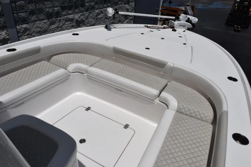 Slide: The Image of 2022 Caymas 26 HB boat interior with cushioned seating and storage compartments. - 11