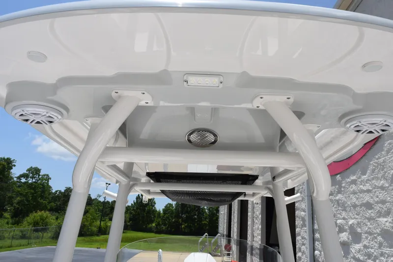 Slide: The Image of 2022 Caymas 26 HB boat T-top with speakers and lighting, outdoor setting. - 13