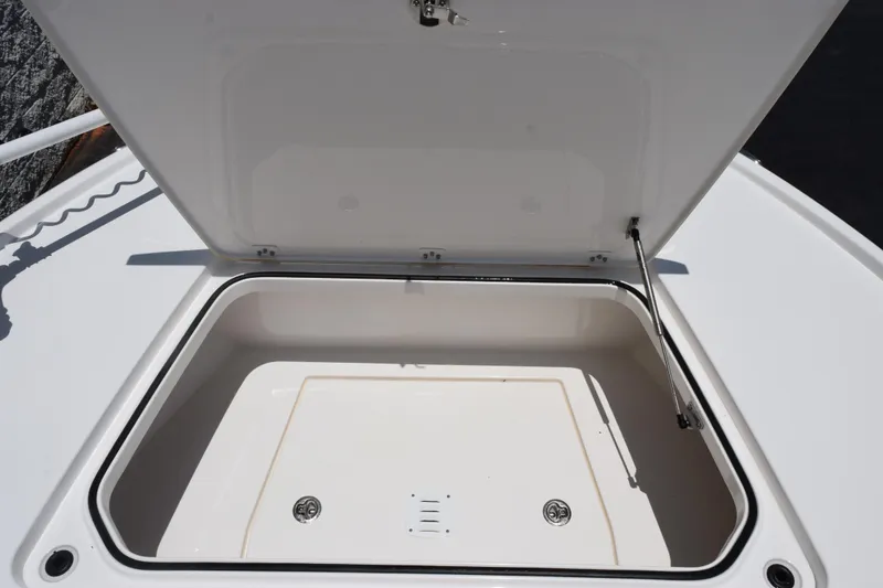 Slide: The Image of Open storage compartment on 2022 Caymas 26 HB boat, showcasing spacious interior. - 15
