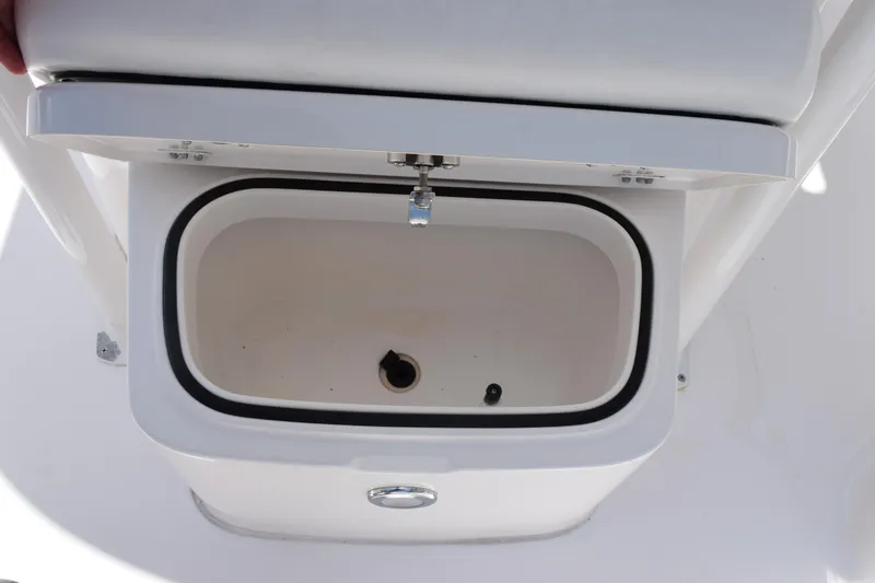 Slide: The Image of Livewell compartment on 2022 Caymas 26 HB boat, featuring a white interior and secure lid. - 16