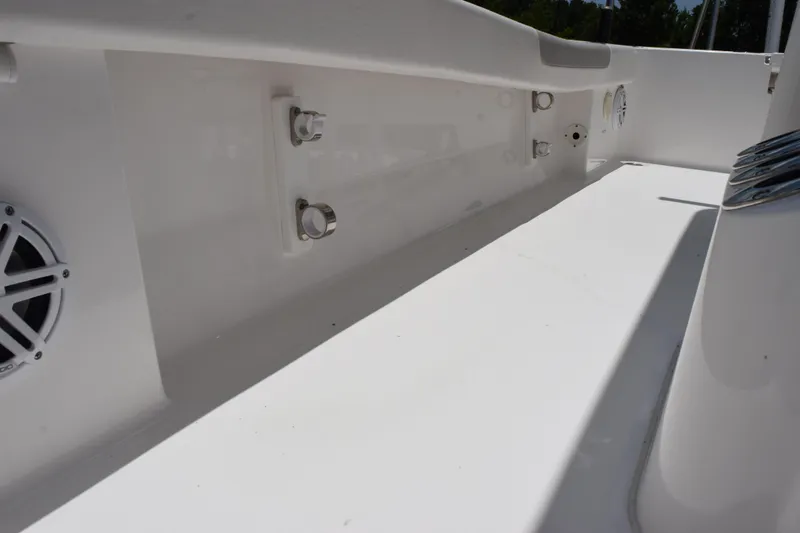 Slide: The Image of Interior view of 2022 Caymas 26 HB boat, featuring sleek white design and speaker detail. - 18