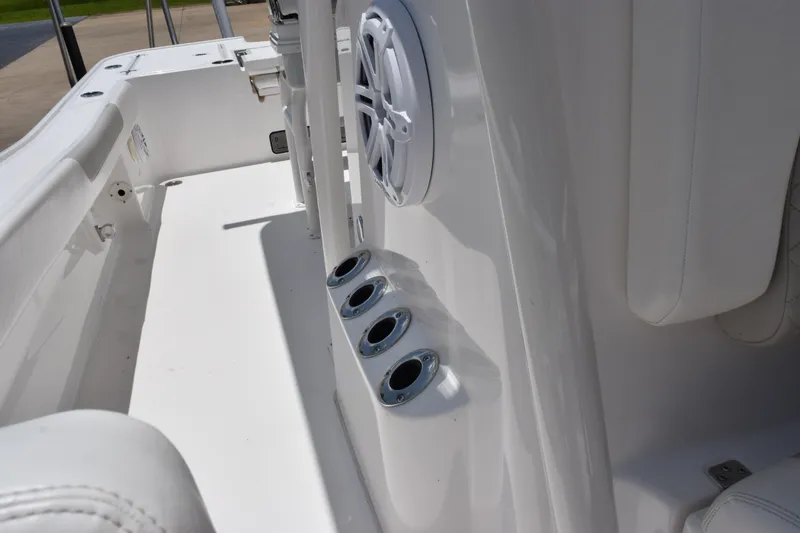 Slide: The Image of 2022 Caymas 26 HB boat interior with rod holders and speaker detail. - 19