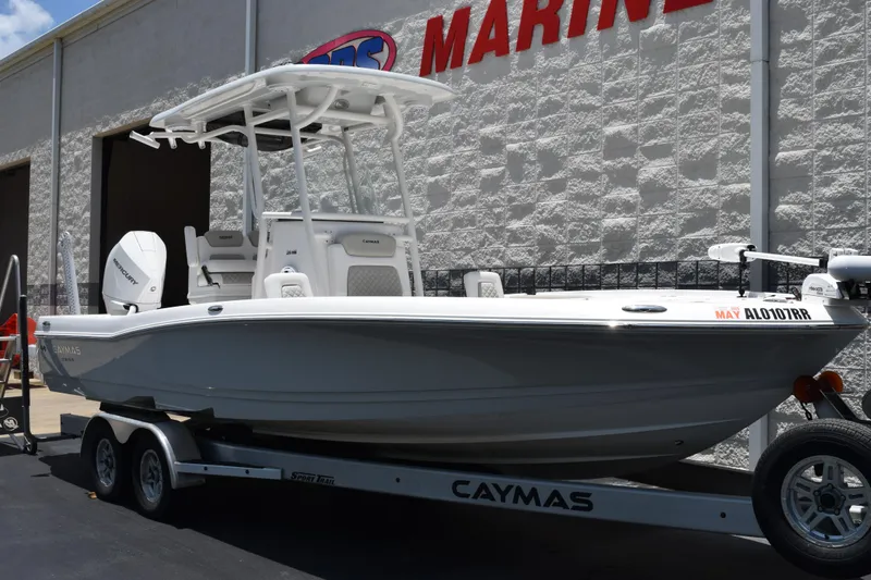 Slide: The Image of 2022 Caymas 26 HB boat on trailer outside marine dealership. - 2