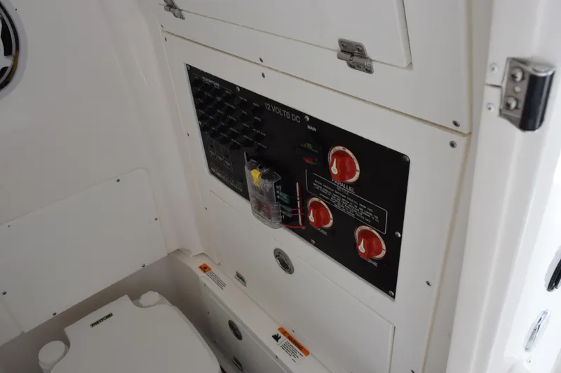 Slide: The Image of Electrical panel inside 2022 Caymas 26 HB boat, featuring switches and controls. - 21